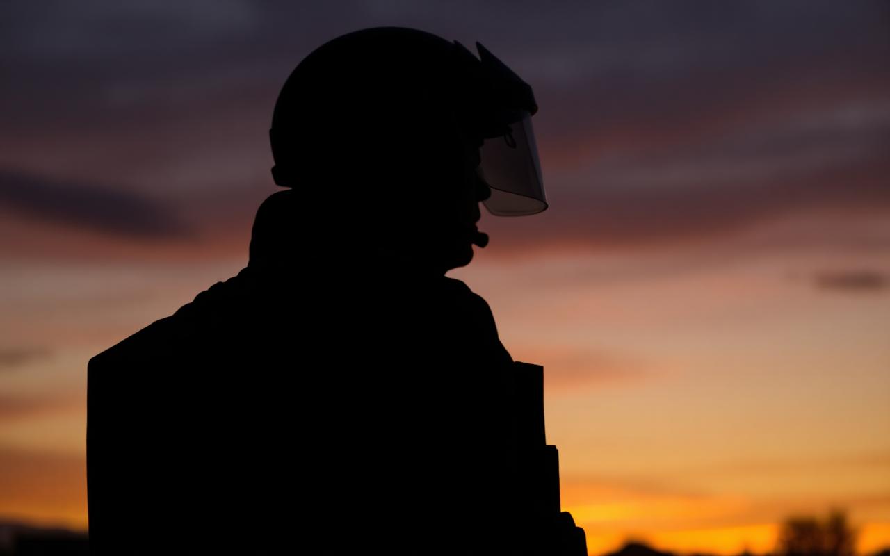 Operator in body armor at dusk